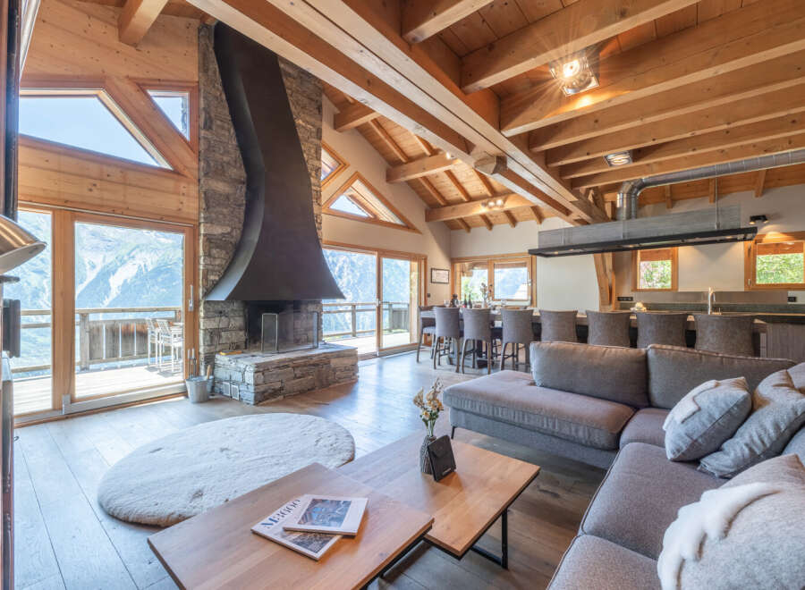 Experience luxury living in this stunning chalet, boasting breathtaking mountain views and a cozy fireplace.