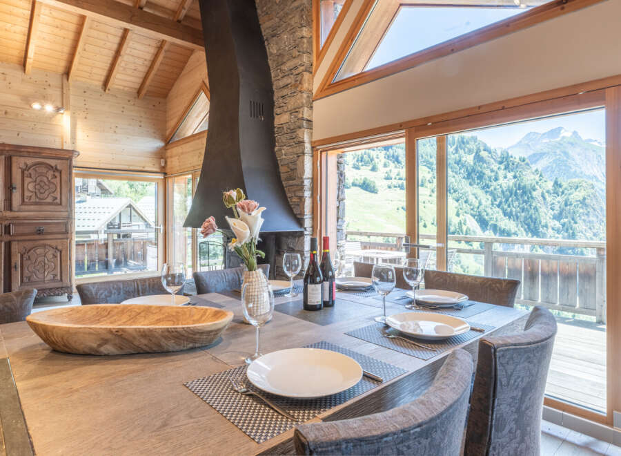 Experience luxury living in this stunning property, featuring a spacious dining area with breathtaking mountain views.