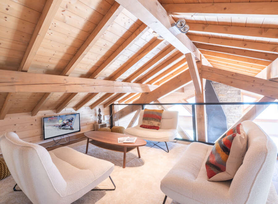 Discover the charm of this stunning property, featuring a cozy living area with a unique wooden ceiling and exposed beams.