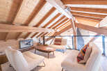 Discover the charm of this stunning property, featuring a cozy living area with a unique wooden ceiling and exposed beams.
