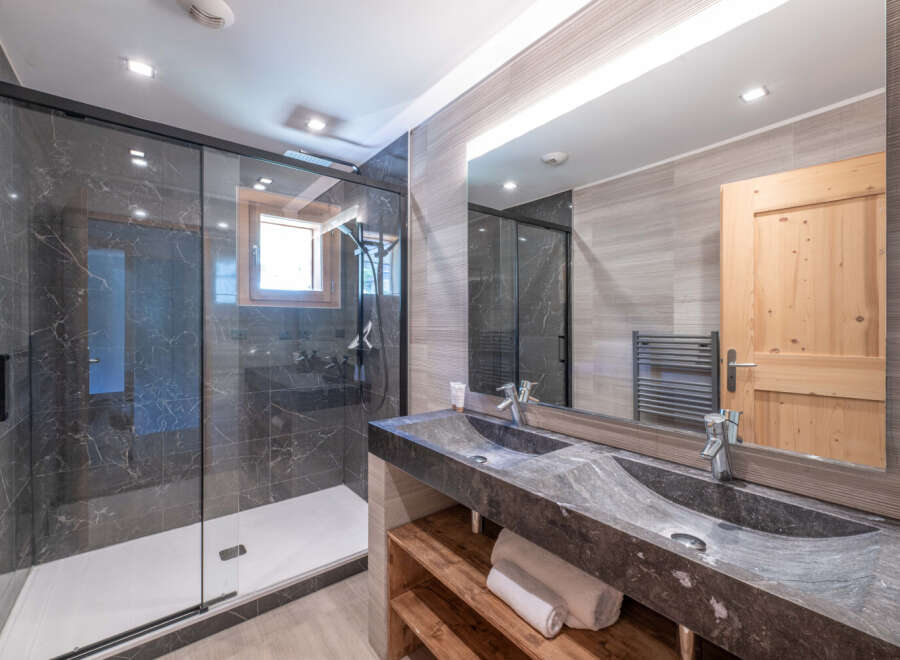 Step into luxury with this stunning bathroom featuring a sleek, modern design.
