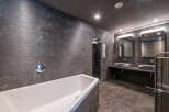 Step into luxury with this stunning bathroom featuring a sleek, modern design.