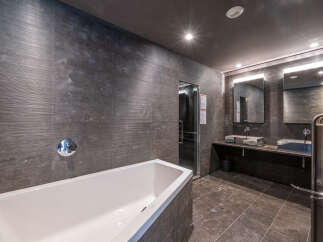 Step into luxury with this stunning bathroom featuring a sleek, modern design.