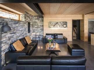 Experience luxury living in this stunning property, featuring a modern interior design with a rustic touch.