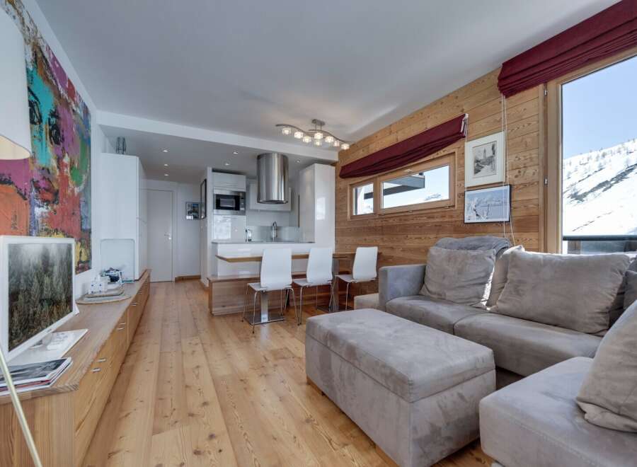 Experience luxury living in this stunning property, featuring a modern kitchen and a cozy living area.