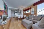 Experience luxury living in this stunning property, featuring a modern kitchen and a cozy living area.