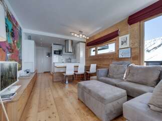 Experience luxury living in this stunning property, featuring a modern kitchen and a cozy living area.