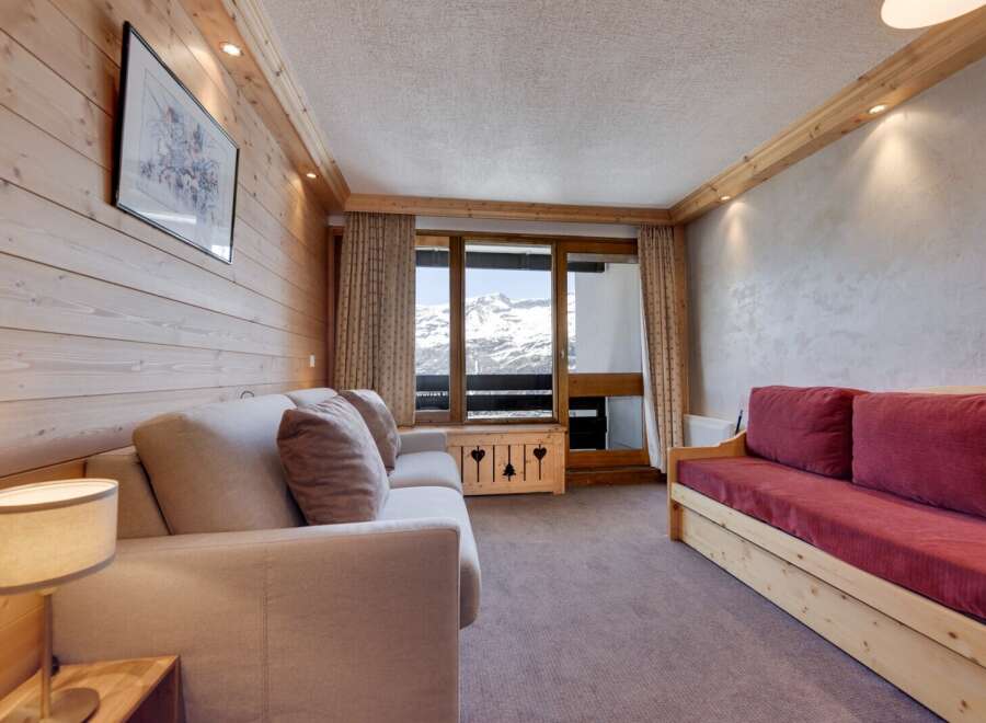 This cozy living space features a warm, inviting atmosphere with its wooden paneling and comfortable seating.