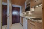 Discover this charming studio apartment featuring a well-equipped kitchenette, perfect for preparing meals.