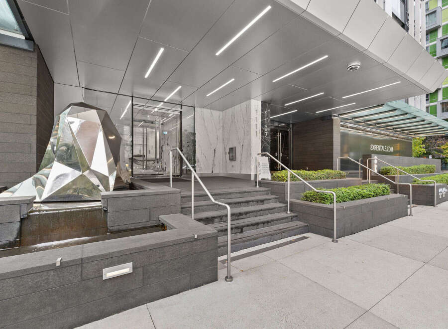 Discover luxury living at this stunning property! Featuring a modern facade with a unique sculpture and elegant entrance, this building offers a sophisticated lifestyle.