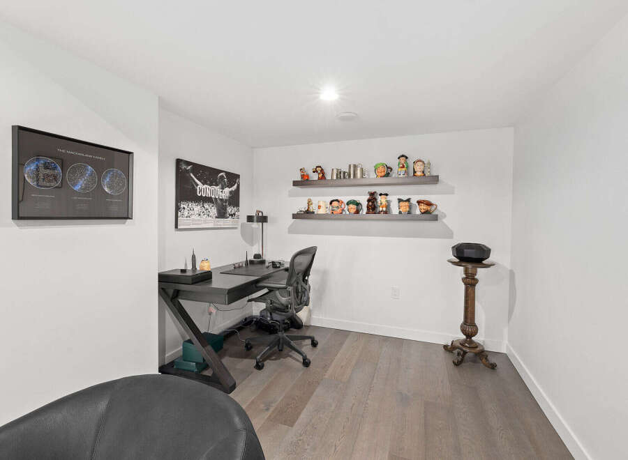 Step into this stylish home office, featuring a sleek desk and comfortable chair, perfect for productivity.