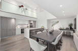 This stunning modern kitchen and dining area boasts a sleek design with high-end finishes.