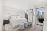 Experience luxury living in this stunning bedroom with breathtaking city views.