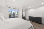 Experience luxury living in this stunning bedroom with breathtaking city views.