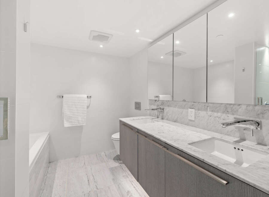 This luxurious bathroom boasts a sleek and modern design, perfect for a sophisticated lifestyle.