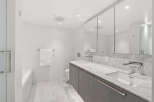 This luxurious bathroom boasts a sleek and modern design, perfect for a sophisticated lifestyle.