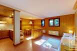 Discover the charm of this cozy property, featuring a warm wooden interior and a well-equipped kitchen.