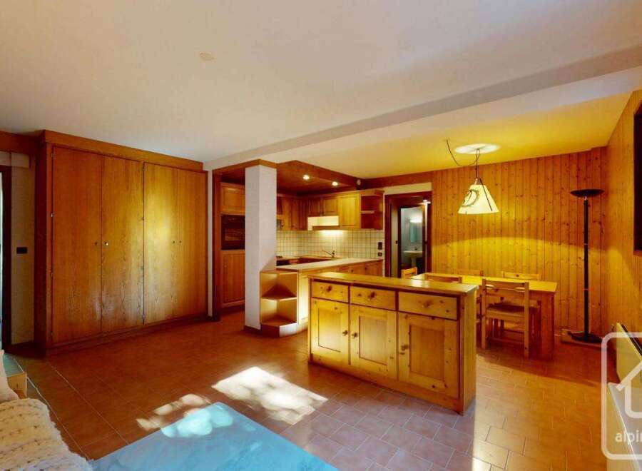 This charming property features a warm and inviting interior with wooden accents throughout.