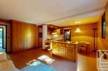 This charming property features a warm and inviting interior with wooden accents throughout.
