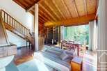 Discover the charm of this inviting property, featuring a warm wooden ceiling and a cozy living space.