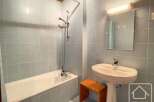 This bathroom features a bathtub and a pedestal sink, offering a functional and classic design.