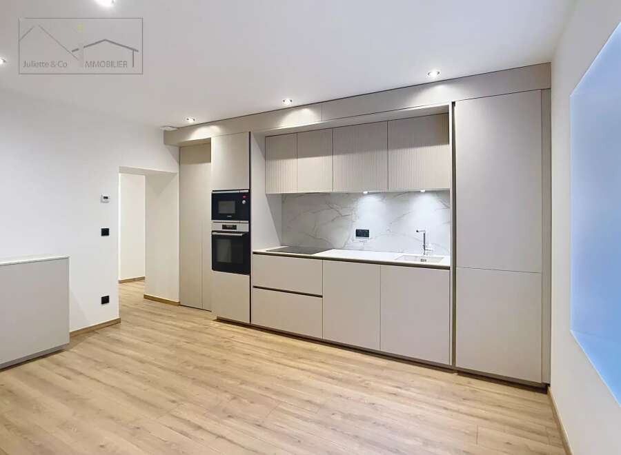 Discover modern living in this stunning kitchen! Featuring sleek cabinetry, integrated appliances, and a stylish backsplash, this space is perfect for culinary enthusiasts.