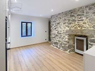 Discover the charm of this unique property featuring a stunning stone wall that adds character and warmth to the space.