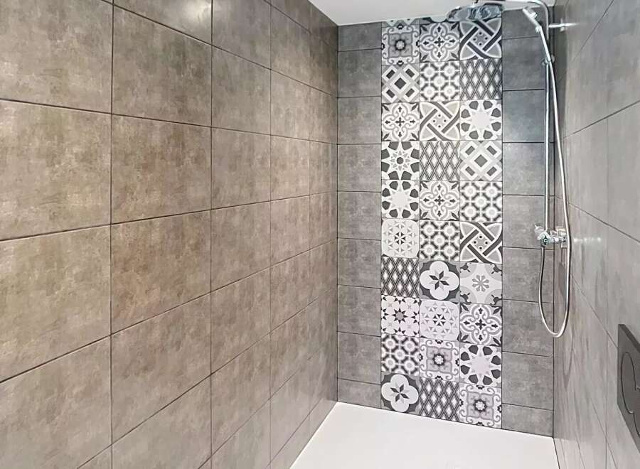 Step into this modern bathroom featuring a stylish shower area.