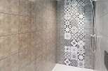 Step into this modern bathroom featuring a stylish shower area.