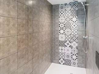 Step into this modern bathroom featuring a stylish shower area.