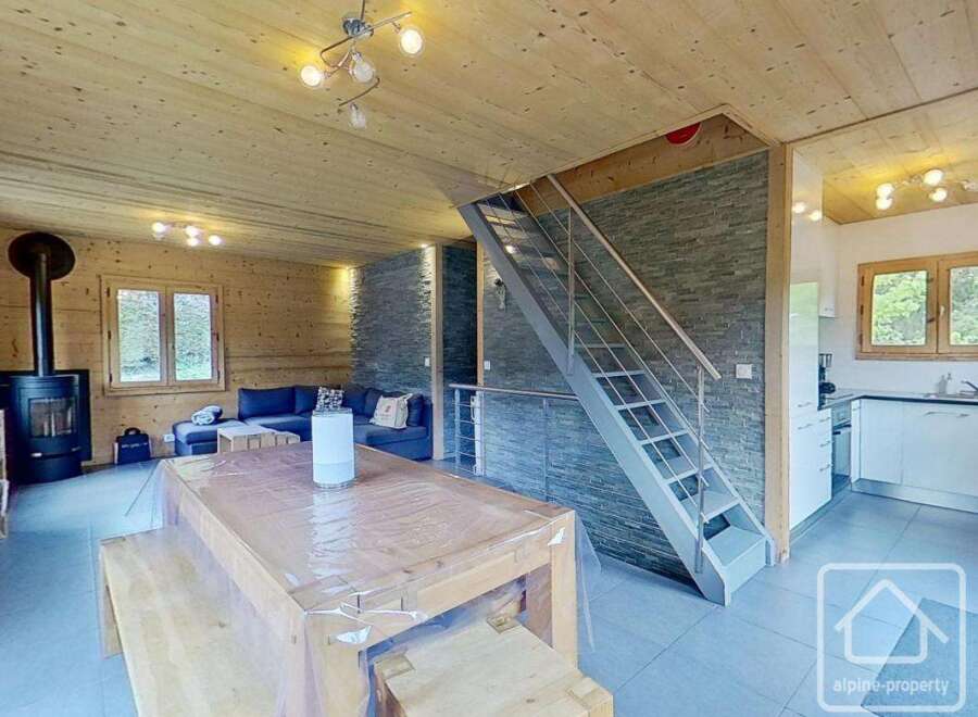 Discover the charm of this stunning property, featuring a cozy living space with a modern fireplace and a stylish staircase.
