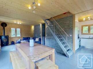 Discover the charm of this stunning property, featuring a cozy living space with a modern fireplace and a stylish staircase.
