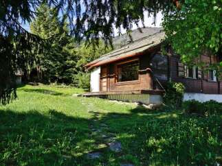 Nestled in a serene natural setting, this charming wooden cabin offers a perfect blend of rustic charm and modern comfort.