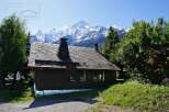 Nestled amidst the breathtaking backdrop of snow-capped mountains, this charming wooden cabin offers a serene escape.