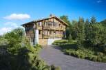 Discover the charm of this stunning wooden chalet nestled amidst lush greenery.