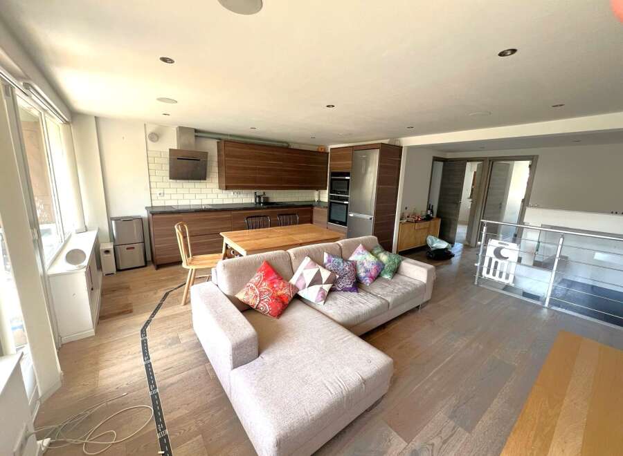 This stunning property features a modern open-plan kitchen and living area, perfect for entertaining.