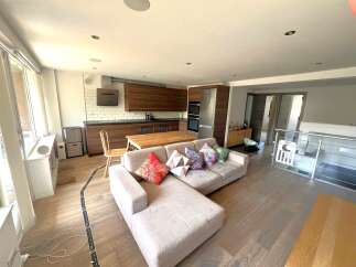 This stunning property features a modern open-plan kitchen and living area, perfect for entertaining.