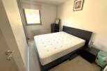 Discover this cozy bedroom featuring a comfortable bed and a stylish nightstand.