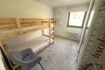 This charming bedroom features a cozy bunk bed, perfect for kids or guests.