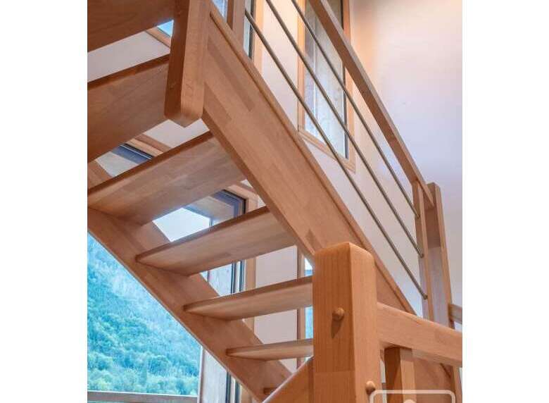 This stunning property features a beautifully crafted wooden staircase, adding a touch of elegance and warmth to the interior.