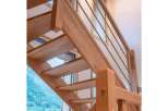 This stunning property features a beautifully crafted wooden staircase, adding a touch of elegance and warmth to the interior.