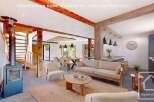 Discover the charm of this stunning property, featuring a cozy living space with a fireplace and a modern kitchen.