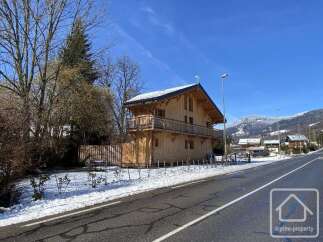 Discover this stunning wooden chalet nestled in a picturesque mountain setting.