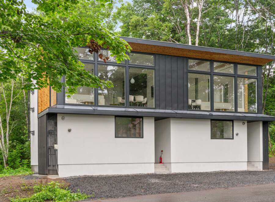 This modern home boasts a sleek design with large windows offering stunning views.
