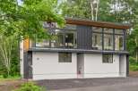 This modern home boasts a sleek design with large windows offering stunning views.