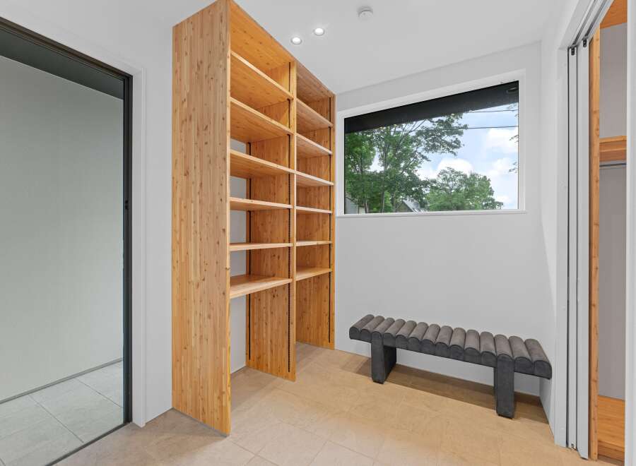 Step into luxury with this stunning property featuring a custom-built wooden shelving unit, perfect for showcasing your belongings.