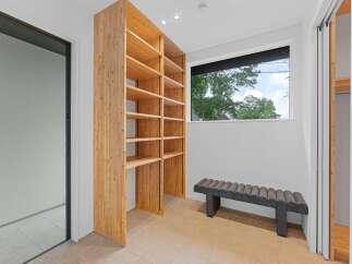 Step into luxury with this stunning property featuring a custom-built wooden shelving unit, perfect for showcasing your belongings.