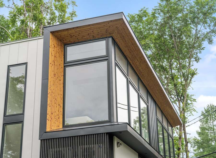 This stunning modern home boasts a striking architectural design with a combination of wood and sleek black accents.