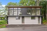 This modern home boasts a sleek design with expansive windows that flood the interior with natural light.