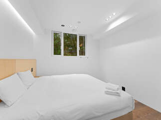 This modern bedroom offers a serene retreat with its minimalist design and bright, airy ambiance.